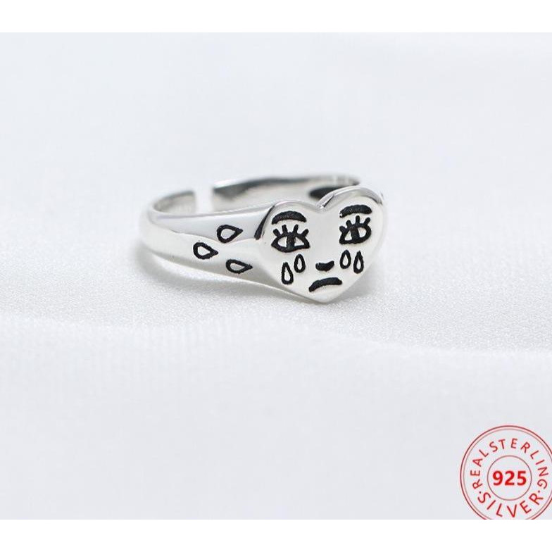Sad face ring